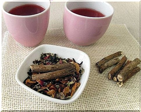 Two cups of licorice root and honey tea and a bowl of licorice root.