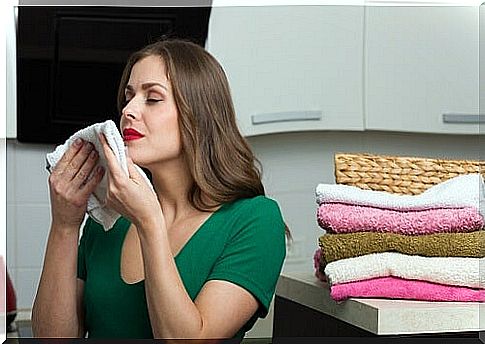 Woman uses fabric softener for laundry