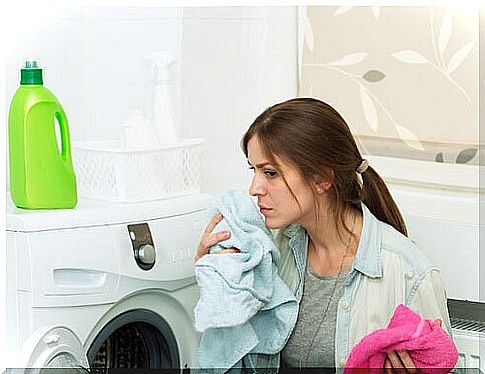 Woman washes laundry and uses fabric softener