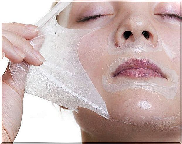 A woman pulls her gelatin and milk mask off her face.