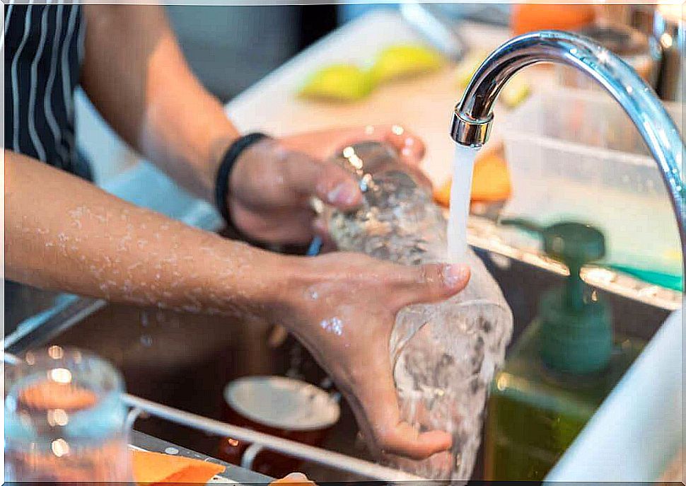 Woman washes glass